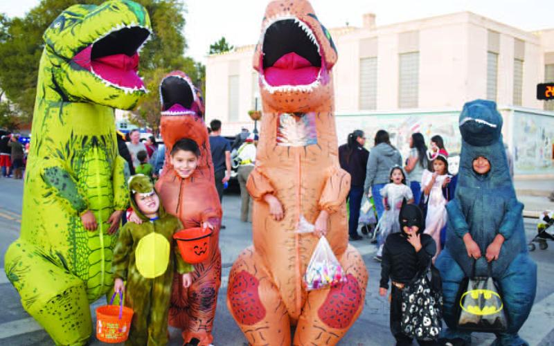 THECRETACEOUSCREW - A large crowd of trick or treaters visited downtown Levelland for the annual Main Street Trunk or Treat, Monday. Lisa Camacho, Isaac Perez, Sergio Perez, Eduardo Gutierrez, Xander Mulloy &amp;amp; Luke Cisneros all gather for one dino-riffic T-Rex photo. (Staff Photo by Delany Jackson)