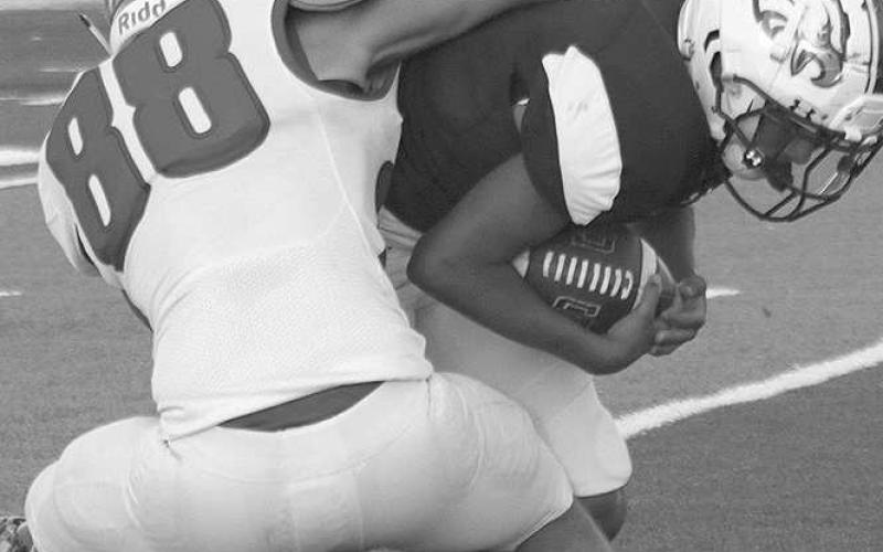 TACKLEFORALOSS- The Sundown Roughnecks traveled to Acuff to face the 3A Roosevelt Eagles on Friday night and left with a three point loss 26-29. Jadon McAdams bulldogs an Eagle rusher for a loss on the play. The Roughnecks have a bye this week and will return to the field for their district opener in Floydada October 7.(Photo Courtesy of Chris Bratcher)