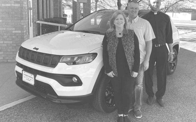 NEW CAR WINNER – Amee Dobson of Levelland was the winner of the 2022 Jeep Compass Latitude 4x4 SUV that was raffled at the conclusion of the 38th Annual Sausage Lovers Festival held recently at St. Michael Catholic Church. Dobson, a 4th grade teacher at Smyer ISD, is pictured with her husband Scott and Father Jonathan Phillips, pastor of St. Michael’s. The winning ticket was sold by parishioner Veronica Muniz. ( Submitted Photo courtesy of St. Michael’s Catholic Church)
