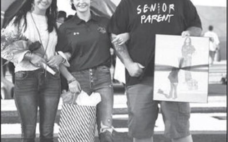 SENIOR TRAINER- Levelland seniors were recognized last Friday during the Lobos home game against Borger. Trainer Laynee Newberry was escorted by her parents Brandon Newberry and Sara Barnes. (Staff Photo by Dom Puente)