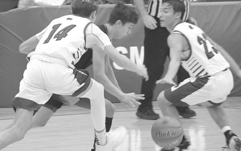TRAP DEFENSE- The Smyer Bobcats finished second in their home tournament with a 56-30 loss to the Wink Wildcats in the championship round Saturday night. The Bobcats will be in Sundown Friday night for a 6:15 p.m. game. (Photo by Jay Kelley)