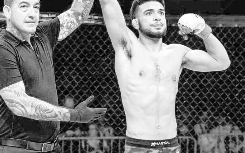 THE VICTOR - Mateo Gonzalez took his fourth professional victory in MMA against Brandon Menneses in the Peak Fighting 29 event, in Amarillo, June 10. Gonzalez is pictured getting his hand raised in victory. (Photo Courtesy of Daisy Murray)