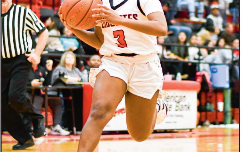 WILLIAMS ON THE GATHER - Levelland Loboette Whitney Williams gather her dribble to go up for a shot during their game at home against Lorenzo this past Tuesday night. Williams would have seven points in the win. (Staff photo by Jentezen Smith)