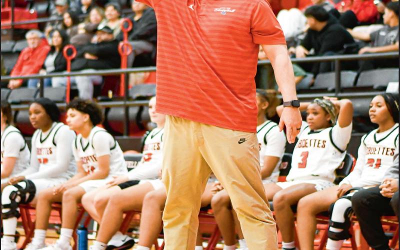 COACHING ‘EM UP - Levelland Loboettes Basketball Head Coach Jacob Bell coaches up his players from the sideline during their game at home against Lorenzo this past Tuesday night. Bell would coach them to a 70-27 win. (Staff photo by Jentezen Smith)
