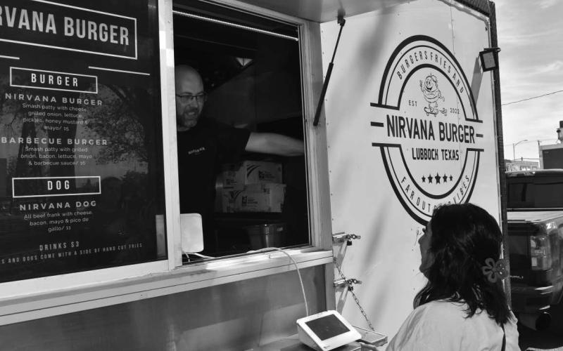 NIRVANA BURGER - It was a successful day for Levelland Main Street and the Food and Food Truck Day which is every third Thursday of each month. Pictured is Jerry Green taking Kayla Blanco’s order in his Nirvana Burger food truck. Additionally businesses in this past Thursdays events were Desert Bloom Bakery, Outlaw Eggrolls, Anderson’s Grill, Mosaic Coffee Co, Bahama Bucks, Wok Bros, Spud Truck and Studio “K” and Smokin D’s. (Staff Photo by Samantha Nowell)