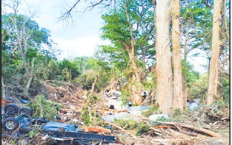 WORKING THROUGH THE DEBRIS - HCSO Investigator Tillman spent a week in the Texas Hill Country offering his assistance with debris removal and recovery following the floods that caused significant damage to the area. Pictured is one of the areas Tillman conducted debris removal with a chainsaw crew near Center Point, Texas. (Photo courtesy of Tillman)
