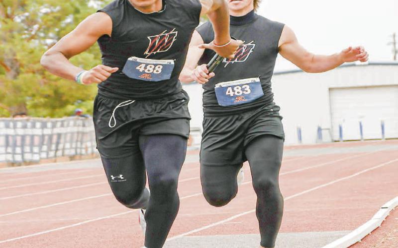 RELAY HANDOFF - Whitharral’s Greg Johnson hands off the relay baton Nate Sansom during the 4x200-meter relay this past Friday at the Regional Championships at South Plains College. (Staff photo by Jentezen Smith)
