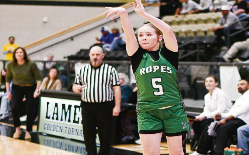 THREE-POINT THREAT - Ropes Lady Eagle Brooklyn Hogg shoots a three-pointer while Lady Eagles Head Coach Marianne Wolfe watches in the background. Hogg would finish with a game-high 17 points. (Staff photo by Jentezen Smith)