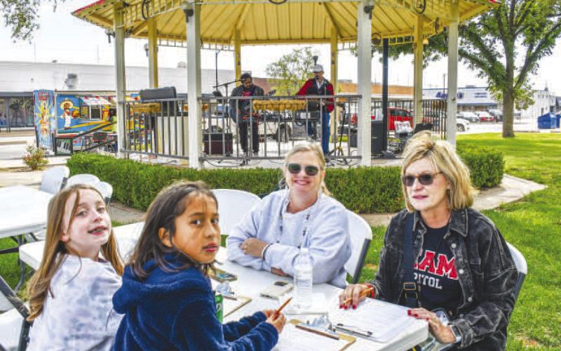 LAST FOOD TRUCK THURSDAY - Levelland Main Street held the last Food Truck Thursday for the year in downtown Levelland around the Hockley County Courthouse lawn. Pictured are Pam Alexander, Barbra Utley, Scout Scott and Courtney Castellano enjoying their time on the courthouse lawn. (Staff photo by Essence Childers)