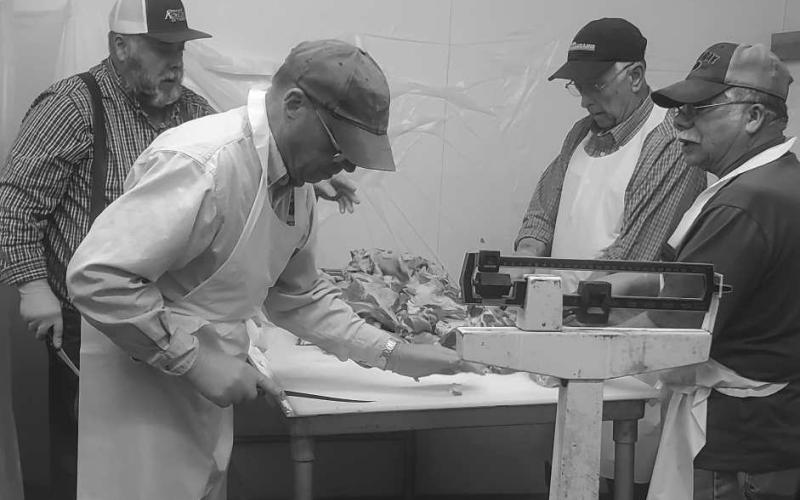 PREPARATIONS FOR SAUSAGE FEST- The St. Micheals Catholic Church in Levelland is having its Annual Sausage Fest on Saturday. In the photo Steven Henry, Kerry Siders, Al Castillo and Ken Miller are volunteering their time to prepare for the festival. (Staff photo by Emily Campos)