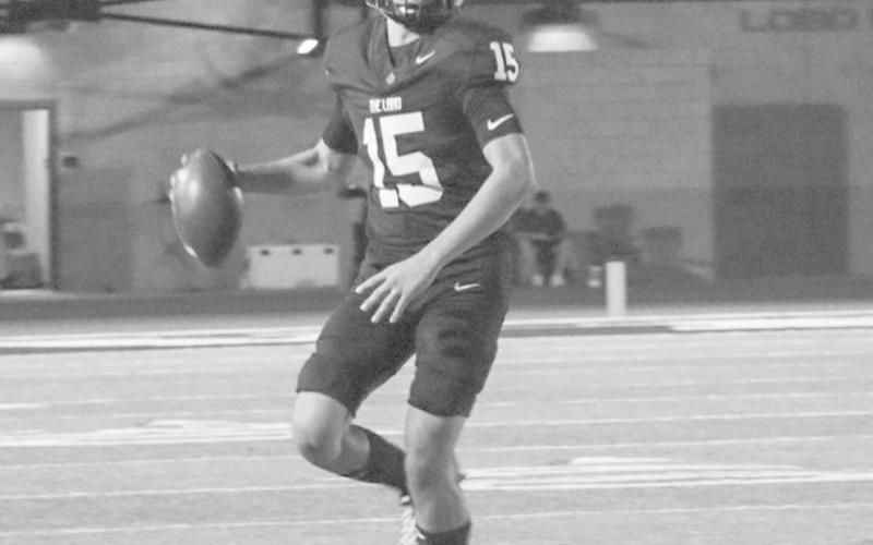 ON THE MOVE - Levelland Lobo Ethan Sanchez scrambled out of the pocket while looking downfield last Friday against the Tigers last Friday at home. (Staff photo by Aalijah Soliz)