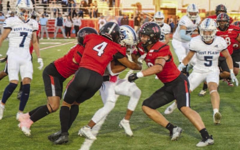 GROUPTACKLE - The Lobo defense flew around last Friday during their competition against the West Plains Wolves. (Staff photo by Dom Puente)
