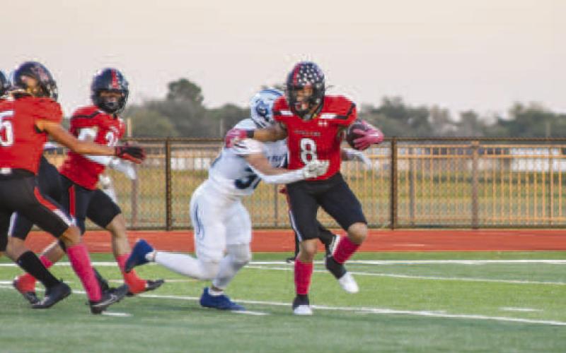 STIFFARM - Levelland wide receiver Kaden Brogden carried the ball for the Lobos offense last Friday against the West Plains Wolves. (Staff photo by Dom Puente)