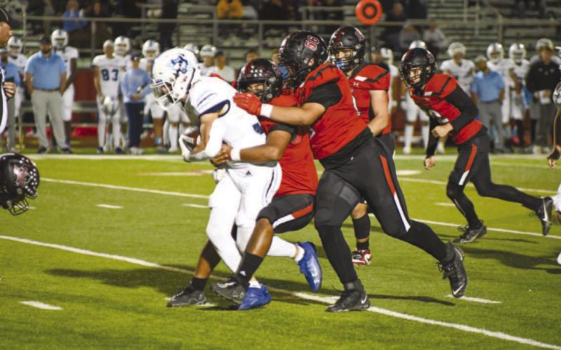 WRAP-UP - The Levelland defense made the tackle on the West Plains player last Friday night in their loss to the Wolves. (Staff photo by Dom Puente)
