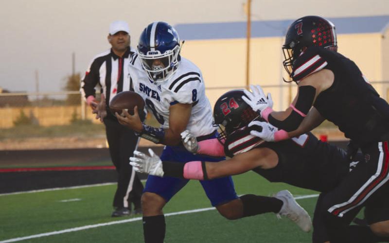 SMOTHERED - Smyer quarterback Peyton Casillas scrambled out of the pocket against the New Home Leopards to pick up some yards. (Staff photo by Aalijah Soliz)