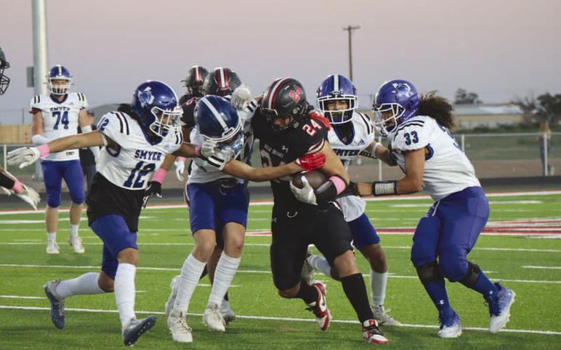DEFENSE - The Smyer Bobcat defense made the tackle on the New Home running back to stop him short of the touchdown. (Staff photo by Aalijah Soliz)