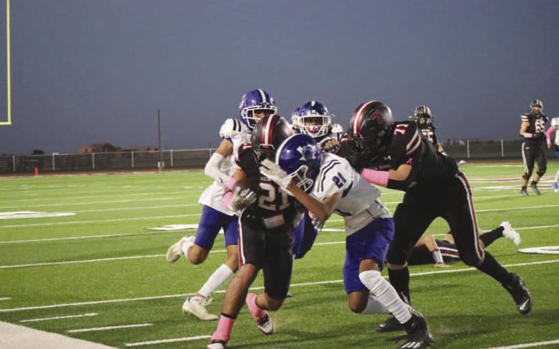 HIT STICK - The Smyer Bobcat defender made a big hit to send the New Home player out of bounds short of the touchdown. (Staff photo by Aalijah Soliz)
