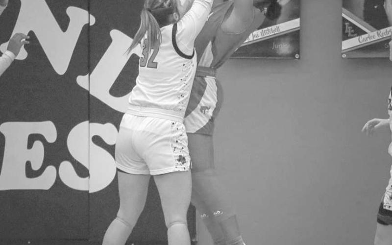 NO EASY BUCKETS - Levelland Loboette Emery Smith smothered her matchup on the way to the basket during the team’s game against the Lady Broncos at home. (Staff photo by Aalijah Soliz)