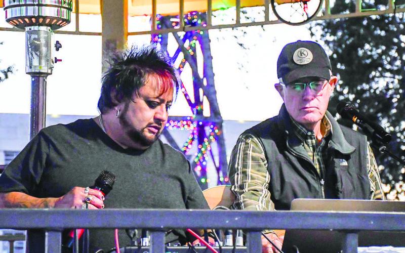 MUSIC ON THE LAWN – Juan Partida and Nick Williams sang and played music for Ladies Night Out attendees at the lit-up courthouse lawn gazebo Thursday night in downtown Levelland. (Staff photo by Evin Thomas)