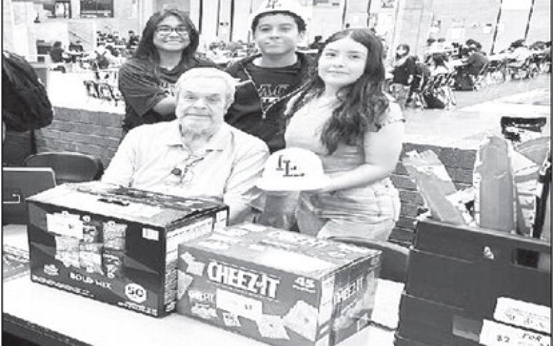 LOS LOBOS: Mr. Hill's LHS Entrepreneur class opened Los Lobos this past week as their class project. They sold $98.00 worth of merchandise in 20 minutes in the Commons area of the high school. They sold snacks, drinks and spirit gear. Pictured are Mr. Russell Hill , Paloma Escamilla, Javier Rogers, Faith Ramos (submitted photo Cristal Isaacks)