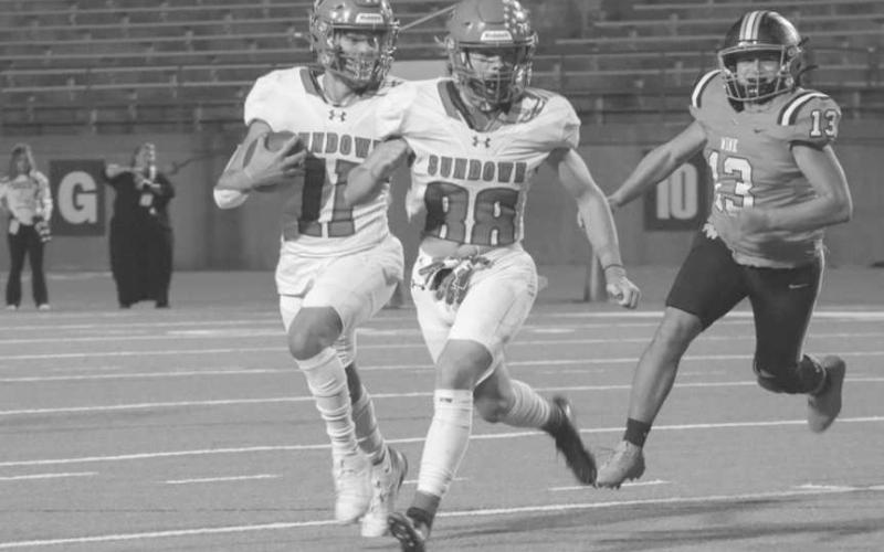 LEAD BLOCKING - Sundown Roughneck Marcus Solis ran behind his lead blocker Toby Lopez last Thursday night in Odessa against Wink in the first round of playoffs. (Staff photo by Aalijah Soliz)