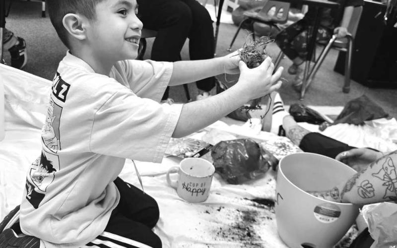 LISD CELEBRATED AG WEEK - The Texas Farm Bureau sent reading teachers their book of the year: How To Grow A Monster by Kiki. Pictured is Xavier Mata planting his spring flower after listening to the Ag Awareness book. (Photo courtesy of Cristal Isaacks)