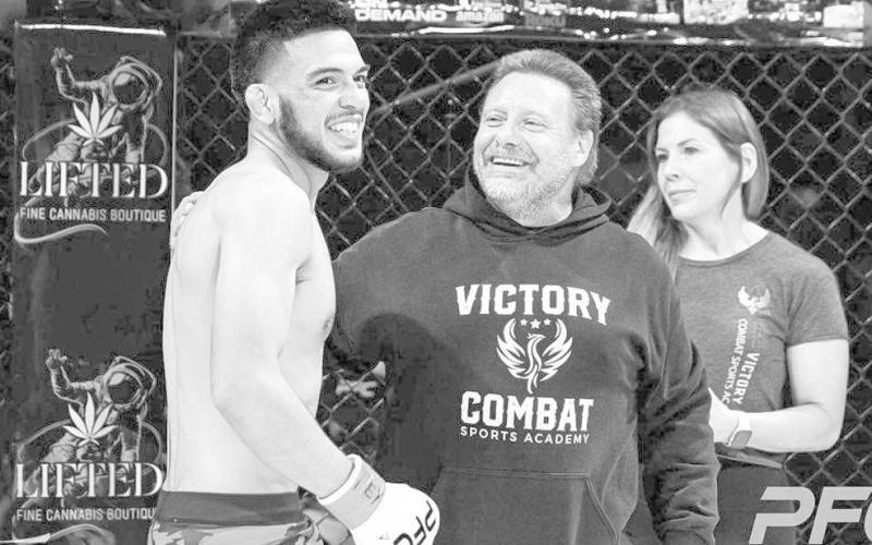 ANOTHER VICTORY - Head Coach John Moore and Shannon Morton congratulated Mateo Gonzalez on his Peak 29 Victory. Gonzalez secured his fourth professional victory by anaconda choke in the first found at the Peak Fighting 29 event, in Amarillo, June 10th. Gonzalez improves to 4-2, after two straight losses. Gonzales is pictured celebrating after his victory. (Photo Courtesy of Daisy Murray)