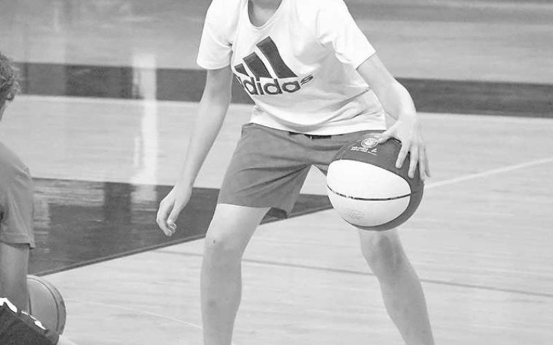 FUNDAMENTALS - Levellands’ Knox Noland practice his dribbling fundamentals and ball control during the Levelland Basketball Camp workouts. Spanning three days of camp time, the campers worked on individual and team drills. (Staff photo by Dom Puente)