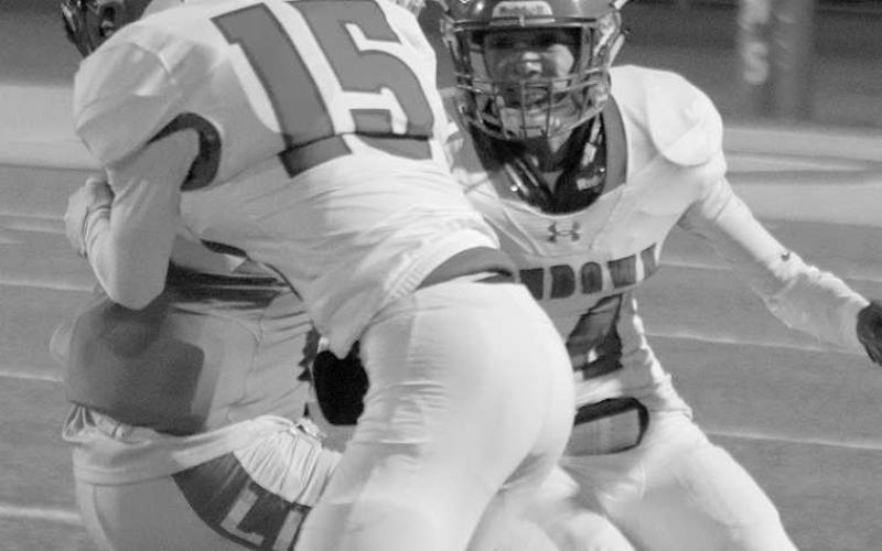 ROUGHTACKLE- Sundown Roughnecks Branson Sanders(15) and Koy Torrres (4) tackled a ball carrier during a road loss to New Deal last Friday. The Roughnecks will play host to the Tahoka Bulldogs on Friday. (Photo Courtesy of Chris Bratcher)