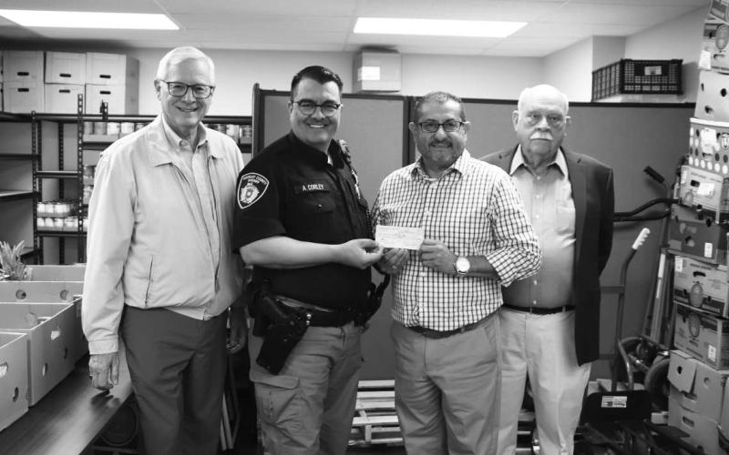 KIND HEARTS - The Levelland Breakfast Rotary Club donated $500 to the South Plains Community Action Food Bank Monday. Pictured left to right: Stephen John, Aryn Corley, Henry Tarango and Bill Powell. (Staff photo by Victoria Byrnes)