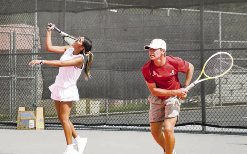 DOUBLE THE TROUBLE – Pictured are Lilly Alvarado and Nathan Ellis who are practicing their serves during the first two-a-day practice of the season for the Levelland Tennis Pack. Photos (Staff photo by Jentezen Smith)