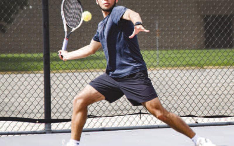 READYTO REACT – Pictured is William Canon getting in position to hit the incoming tennis ball during a reaction drill at the Levelland tennis practice. (Staff photo by Jentezen Smith)