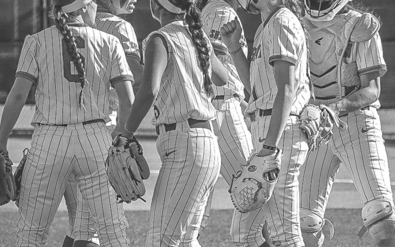 GROUPED UP - The Sundown Roughettes gathered around the mound during their contest against the Sunray Lady Cats last Saturday after getting a batter out. (Staff photo by Aalijah Soliz)