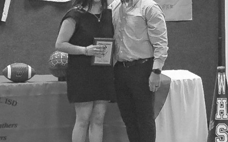 TUCKER PARKINSON MEMORIAL AWARD - Whitharral Panthers Copper Popelka and Lady Panther Tucker Parkinson earned the award this past Monday for their fallen teammate and friend that passed away this school year. Popelka is not pictured as he was at State for golf. Pictured above is Head Football Coach Jeremy Holt and Tucker Parkinson with the award. (Staff photo by Aalijah Soliz)