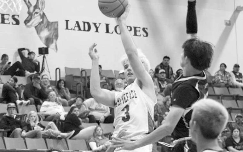 BUCKET IN TRAFFIC- The Antelopes won the Way Out West Basketball Tournament in Whiteface over the weekend. Ethan Kauffam scored two points in traffic during the title game against Plains. (Photo Courtesy of Holly Crutcher)