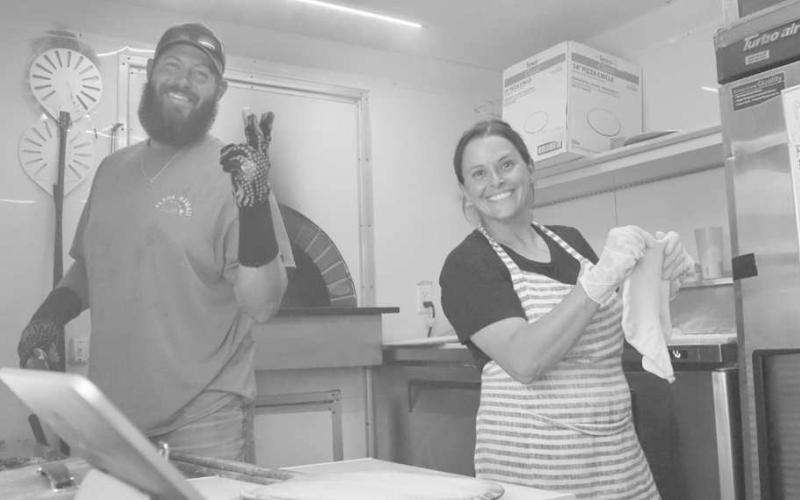PIZZA - Rollin Woodfired Pizza were out this past Saturday at the last Saturday Shop on the Square for the year. They were selling freshly made pizzas. Pictured above are Sam Hoel and Hunter Scott. (Staff photo by Aalijah Soliz)