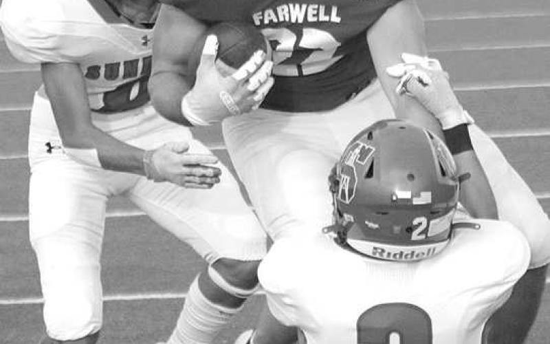 SECURINGTHETACKLE- Sundown Roughneck Jayson Martinez secured a tackle as Jaryn Flores came in to help finish off the play. The Roughnecks fell to Farwell, 49-0. Sundown will welcome Wink into for homecoming Friday September 16. Kick is scheduled for 7:30 p.m. (Photo Courtesy of Chris Bratcher)