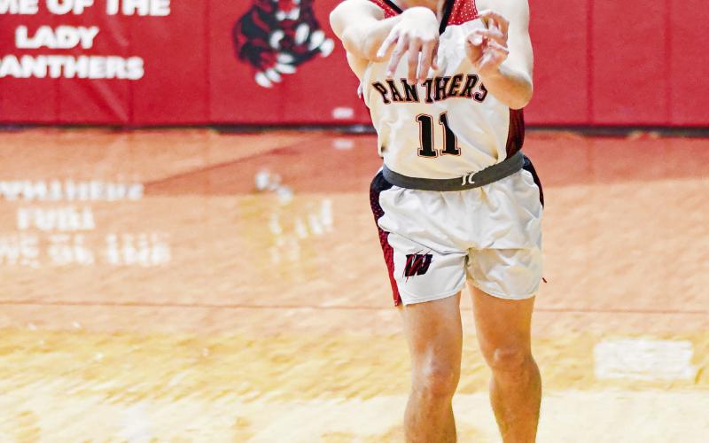 THINK FAST! - Whitharral Panther Ayden Dockery passes the basketball to a teammate during their game against Southcrest this past Thursday at home. (Staff photo by Jentezen Smith)