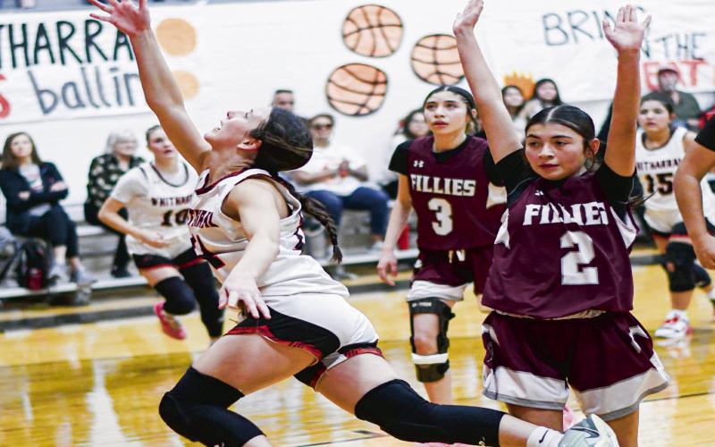 PLAY THROUGH THE FOUL - Whitharral Lady Panther Paige Smith gets tripped by a Bovina defender and still gets up a shot during their game this past Thursday. (Staff photo by Jentezen Smith)