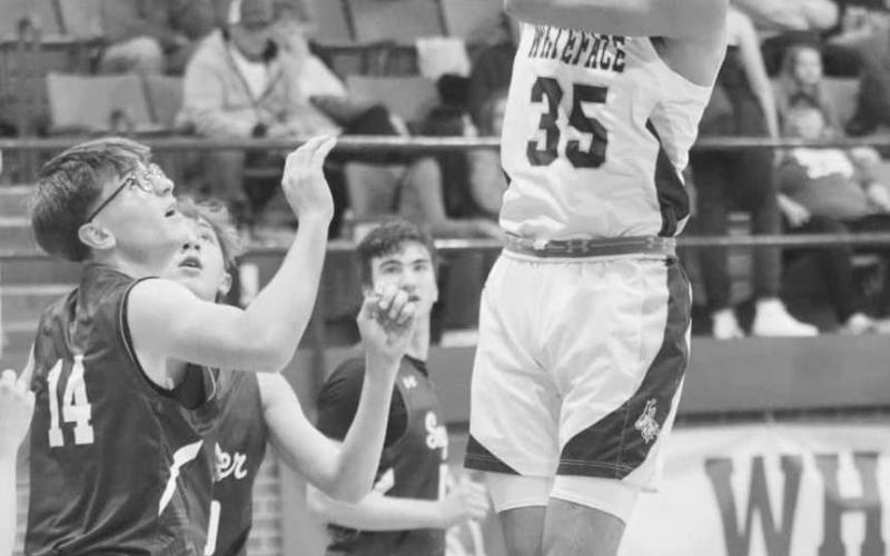CLOSE SHOT - Whiteface Antelope Isaak Lopez shot the ball over the Smyer defenders during the team’s district matchup in Whiteface. (Staff photo by Aalijah Soliz)