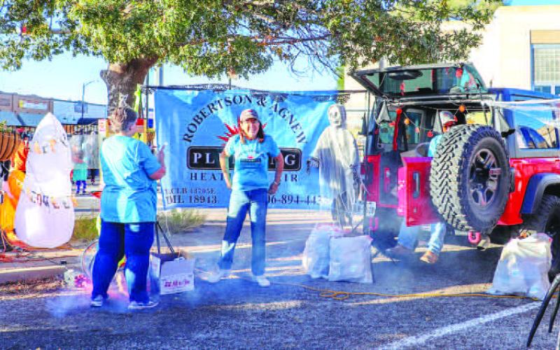 POPCORN TIME- Robertson &amp;amp; Agnew Plumbing Heating &amp;amp; Air handed out popcorn to the trick-or treaters at the Trunk or Treat on Halloween. Many families in the community attended the annual event. (Staff photo by Essence Childers)