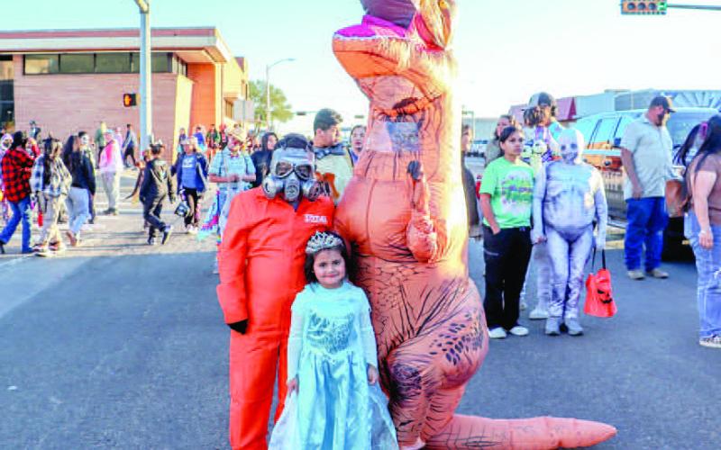 FAMILY FUN- Cousins Tristan Dominguez, Axel Escobedo and Sophia Pedina stopped for a photo on the Levelland Square at the Levelland Main Street and Levelland Noon Lions Club Trunk or Treat held on Halloween, this past Thursday. Famalies were given treats and prizes throughout the night. (Staff photo by Essence Childers)