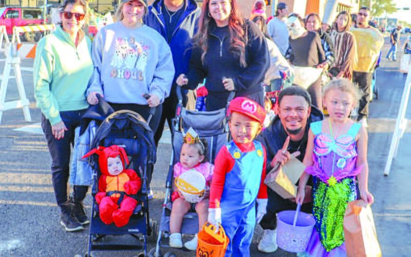 FUN WITH FRIENDS- Levelland Head boys basketball coach Kendall Durrett and wife Mayce Durrett attended the Levelland Main Street and Levelland Noon Lions Club Trunk or Treat alongside their good friends Avery and Carlos Frank this past Thursday. Also pictured are Kye and Kambree Durrett, Kynslee Frank and Kelly Read. (Staff photo by Essence Childers)