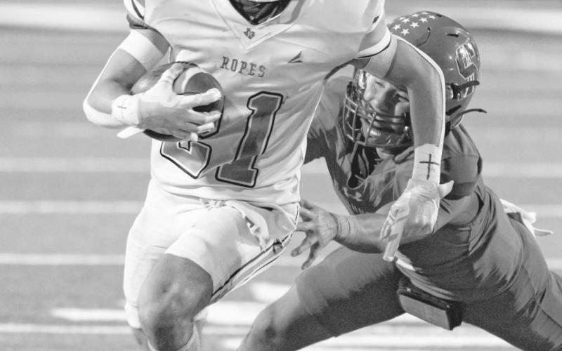 HOT PURSUIT - Ropes Eagle Kolter Dockery was trying to outrun a Sundown Roughneck this past Friday night in Sundown during the team’s district matchup. (Photo courtesy of Donovan Martin)