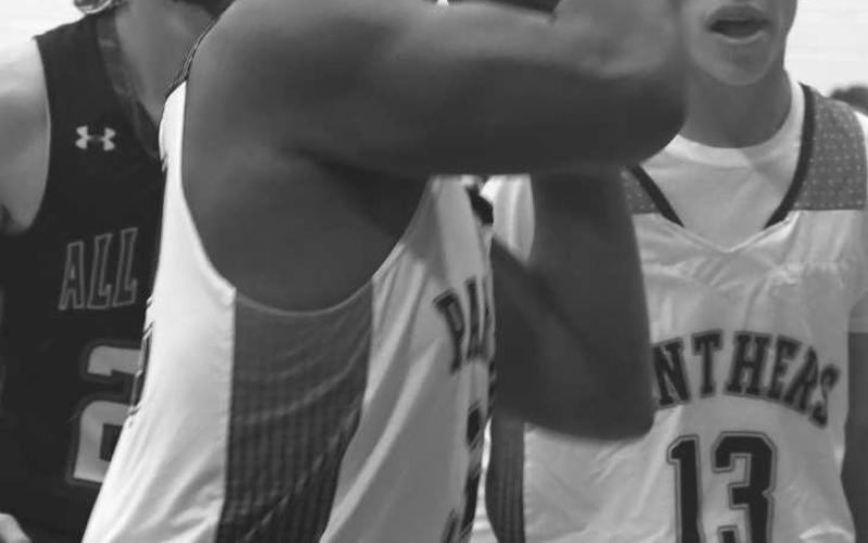 CONCENTRATION - Whitharral’s Nate Sansom was defensive most valuable player in the Whitharral Invitational High School Basketball Tournament last weekend. The Panthers went 2-1, falling to the All Saints Episcopal Warriors 49-37 in the championship game Saturday night. (Staff photo by Jay Kelley)