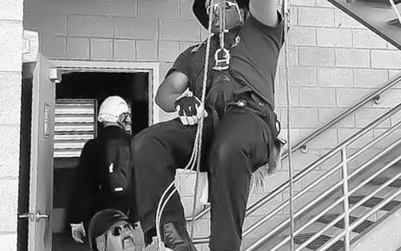 MAKING EACH OTHER BETTER - Levelland Firefighter Derrick Lewis was brought up the training tower at the Lubbock Area Fire Conference while Whiteface Asst. Fire Chief Justin Heflin held slack. The conference is an annual training event for south plains fire departments put on by the Texas A&amp;amp;M Extension School and hosted by Lubbock Fire Rescue at their training field. (Photo courtesy of Tammatha Levell)