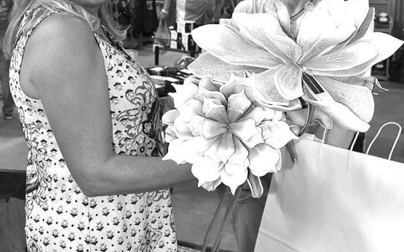 ANTIQUE DECOR GALORE!– Wendy Swarb of Sudan was shopping for antique flowers in Sherry Spiller, of Lubbock, booth at the annual Petticoats on the Prairie held Friday and Saturday at the Mallet Event Center and Arena. The ladies had more than 100 booths to find the perfect home decor. (Staff Photo by DeeLaine Ruiz)