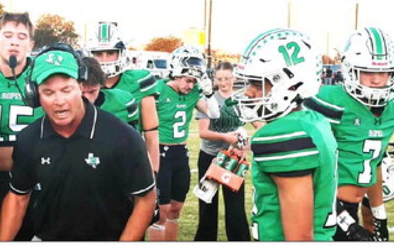 Ropes Eagles Head Coach Beau Riker gives instructions during the winning game against the Plains Cowboys.