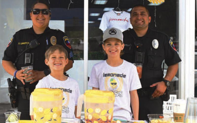 LEMONADE DAY - Levelland police officers make an appearance at First Saturday Shop the Square and Lemonade Day on the downtown Levelland square Saturday supporting the booth Lemonade Boss. Best lemonade won a $200 downtown dollar prize and best decorated won a $100 downtown dollar prize. (Staff photo by Victoria Byrnes)