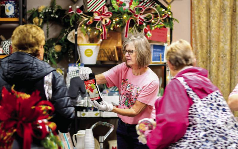 DOWNTOWN FUN - The Main Street Ladies Night Event was held last Thursday evening in downtown Levelland which allows shoppers to enjoy a night to themselves with food and drink while exploring various downtown businesses that are locally owned. Pictured are shoppers looking at the various items Lou Dees Floral and Gifts has to offer. (Staff photo by Myra Guerrero)